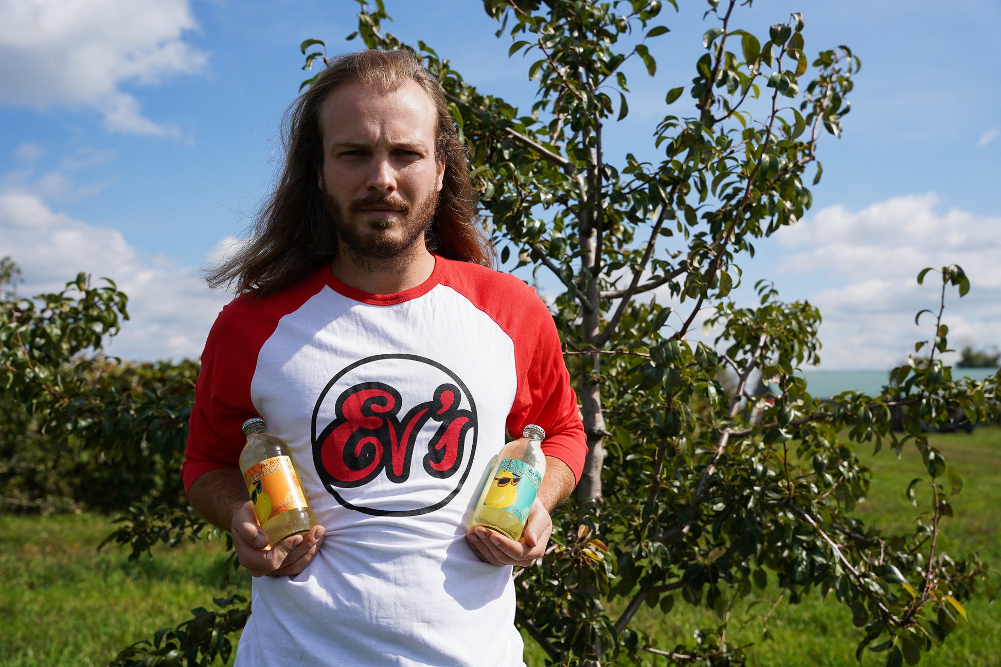 Mitch with Ev's Eclectics Baseball Tee in the orchard