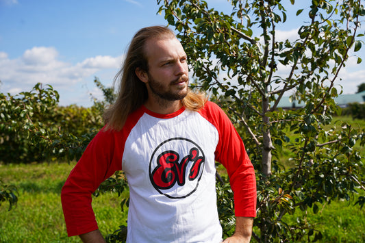 Mitch with Ev's Eclectics Baseball Tee in the orchard